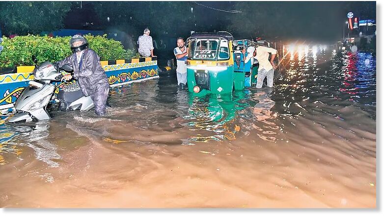 Click to enlarge Commuters forced to push their vehicles that were stranded on the flooded