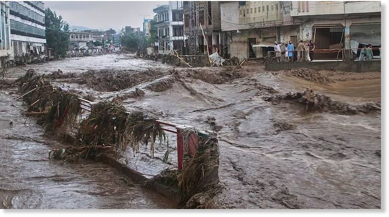 Local residents look at flash flooding due to heavy rains in a neighborhood of Mingora, the main town of Swat Valley, northwestern Pakistan.