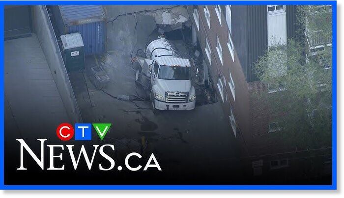 Cement truck stuck in sinkhole beside Toronto apartment building