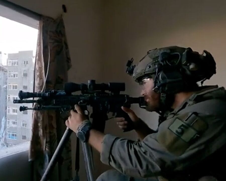 Click to enlarge Israeli soldiers showing the two snipers aiming their weapons through a window and a hole in the wall.