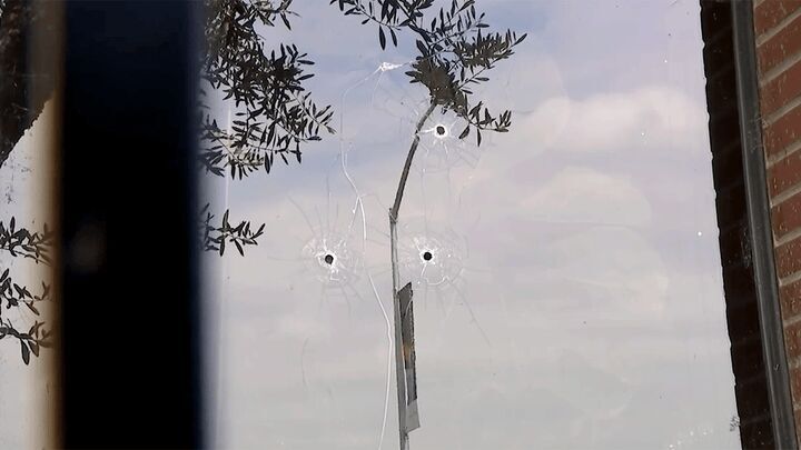 Bullet holes struck through a window at ABC10 in Sacramento, California.