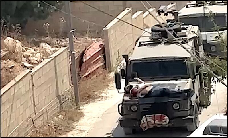 Click to enlarge man strapped to truck