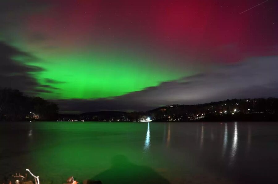 Click to enlarge The aurora brightens the sky over Putnam Lake in Patterson, N.Y., on Tuesday.
