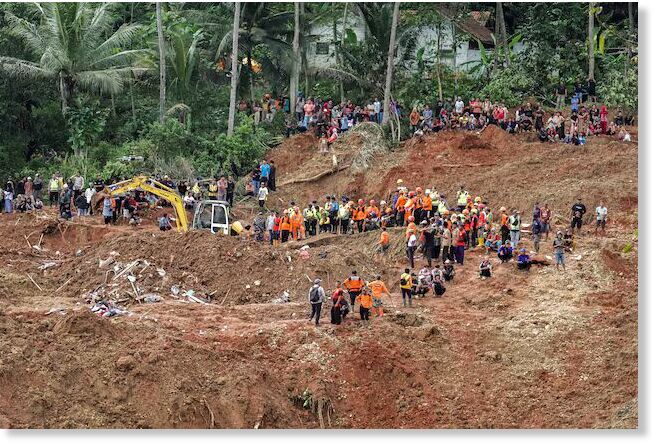 Click to enlarge Indonesian rescue members search for victims at the site of a landslide, which hit Cibeunying village on November 13, in Cilacap, Central Java province, Indonesia, November 15, 2025.