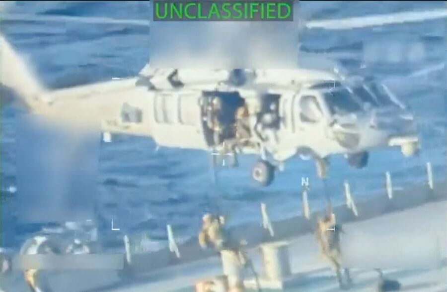 Click to enlarge U.S. forces abseil onto an oil tanker during a raid described by U.S. Attorney General Pam Bondi as its seizure by the United States off the coast of Venezuela, December 10, 2025, in a still image from video.