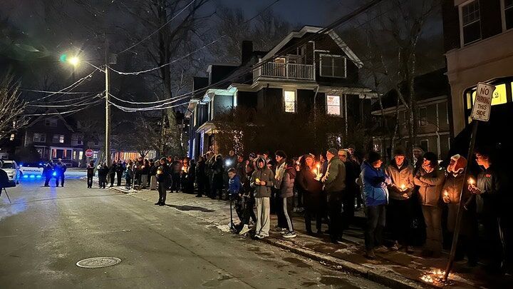 Click to enlarge A crowd of people holding candles gather outside the home of Massachusetts Institute of Technology professor Nuno F.G. Loureiro