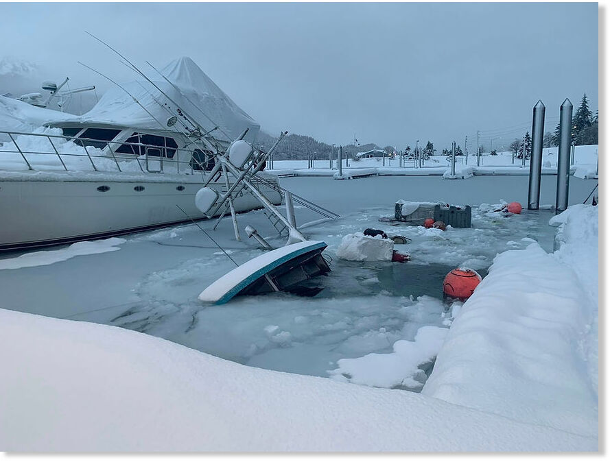 Click to enlarge A submerged boat in a Juneau harbor on Wednesday, Dec. 31, 2025, one of eight that have sunk during the current record snowstorm, according to officials.