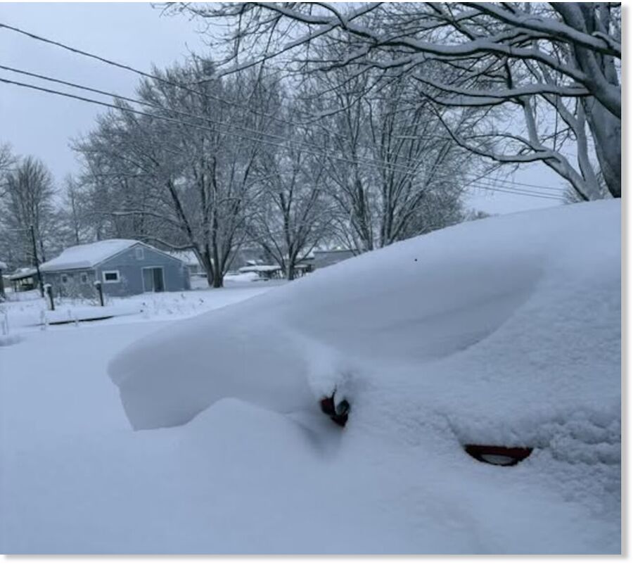 A car is buried in snow in Sandy Pond, Oswego County, where 3 to 4 feet of snow have fallen in the past 24 hours.