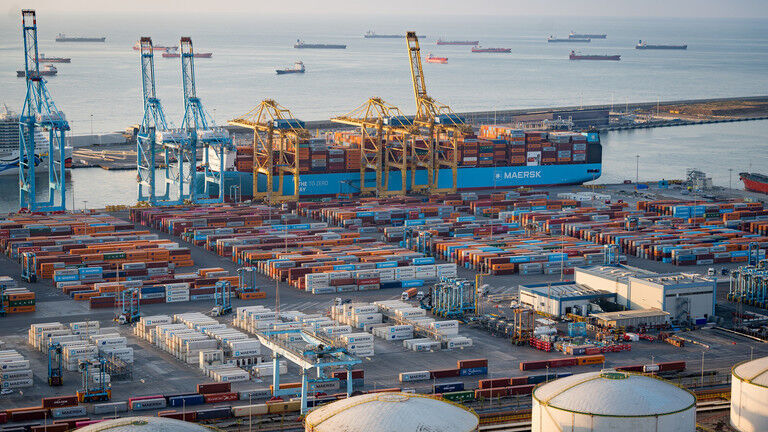 Shipping containers and cargo ships at the Port of Barcelona, Spain.