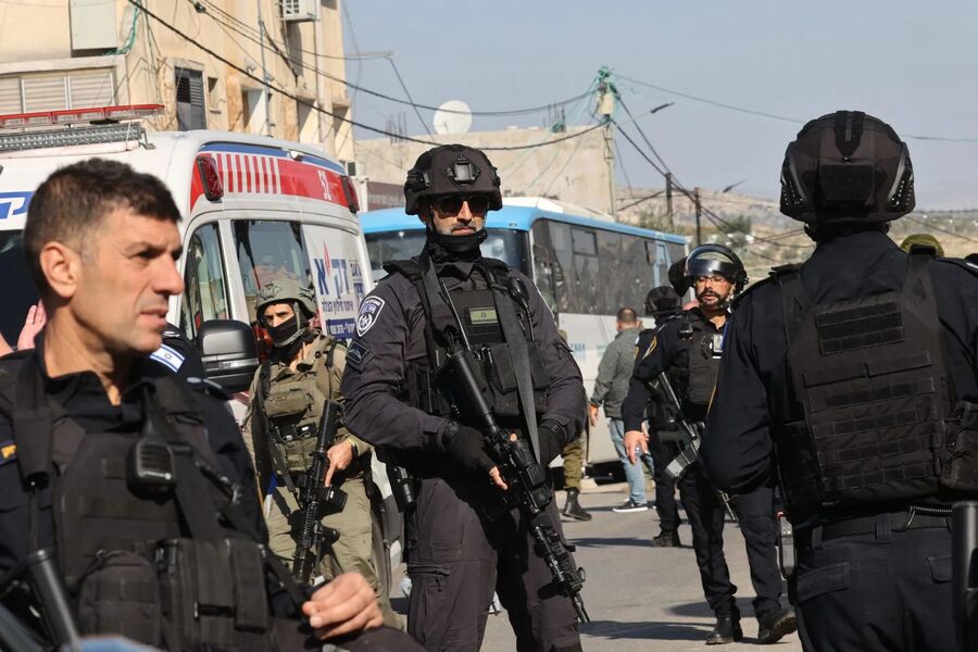 Israeli security forces gather at the site of an attack near the village of al-Funduq