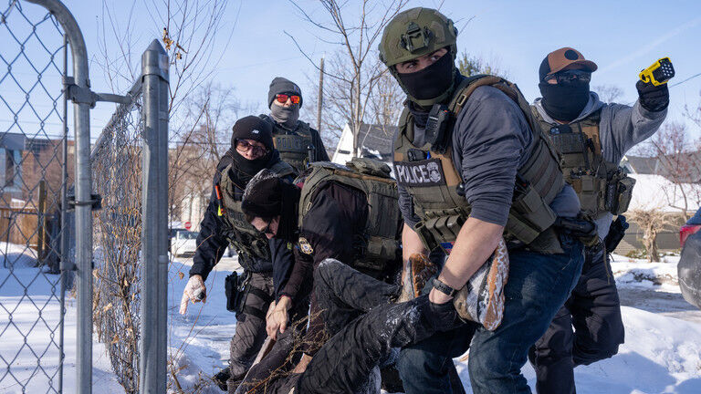 Click to enlarge US Federal immigration agents arrest a protester in Minneapolis