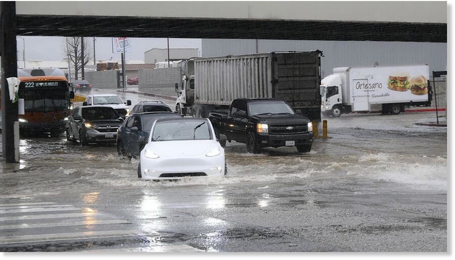 Click to enlarge Cars pass on flooding water at Sawtelle neighborhood during heavy rain in Los Angeles, California, United States on February 16, 2026.
