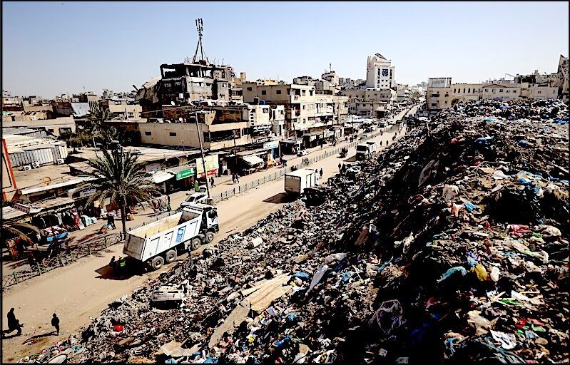 Click to enlarge Gaza rubble and trucks