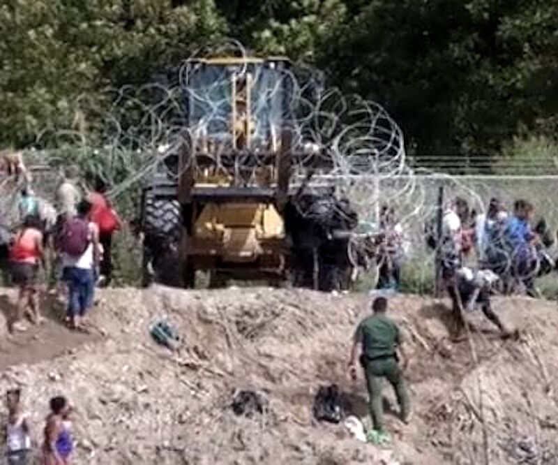 Click to enlarge biden migrants border razor wire forklift