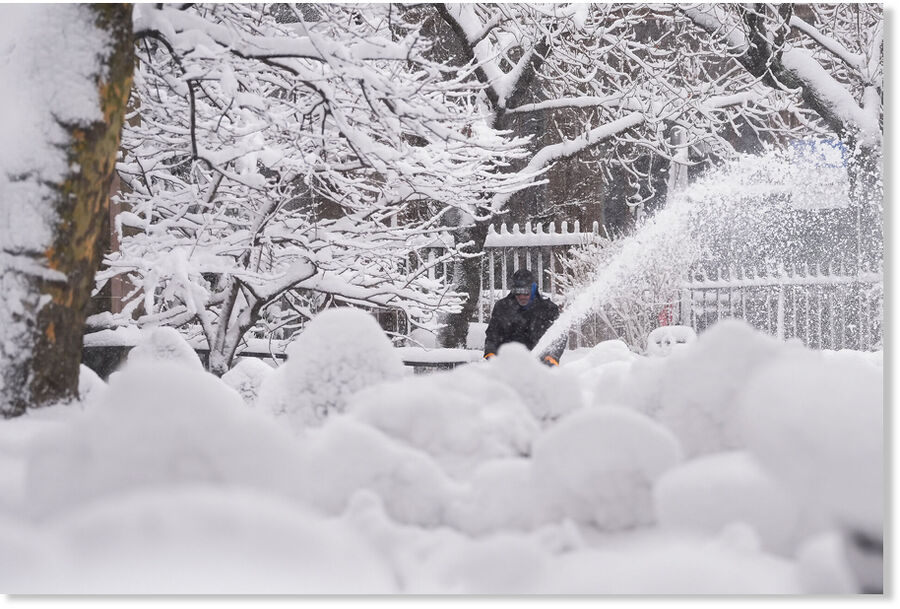 Click to enlarge A groundskeeper clears snow from the walkways inside the Trinity Church graveyard in lower Manhattan during a snow storm, Monday, Feb. 23, 2026, in New York.