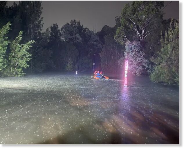 Emergency crews rescue people from flood waters in Fairfield, Sydney, on Thursday night.