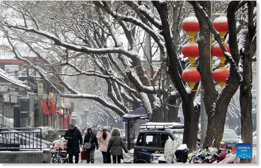 Click to enlarge Citizens walk on a street in Beijing, capital of China, on March 5, 2026. Beijing has witnessed a spring snowfall from Wednesday to Thursday.
