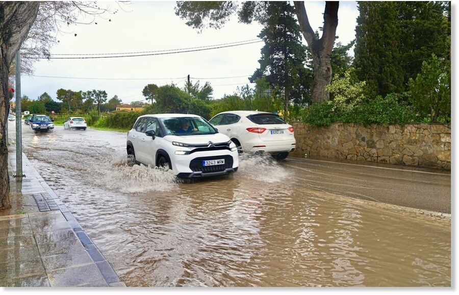 Click to enlarge Vehicles drive through floodwater on a street in Spain after record winter storms brought the heaviest rainfall in nearly 50 years.