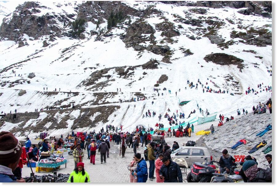 tourists enjoy fresh snowfall near Atal Tunnel North Portal in Lahaul and Spiti district, Himachal Pradesh on Sunday, April 12, 2026. (Photo: IANS)