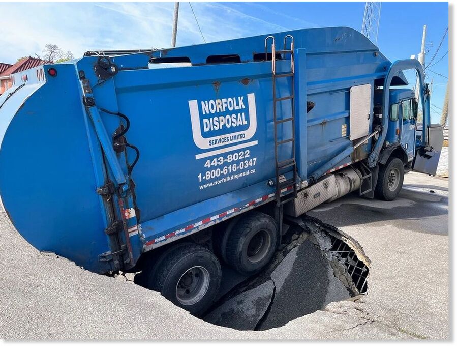 A Norfolk Disposal truck sank into a hole in a parking area on Tuesday morning in downtown Simcoe.