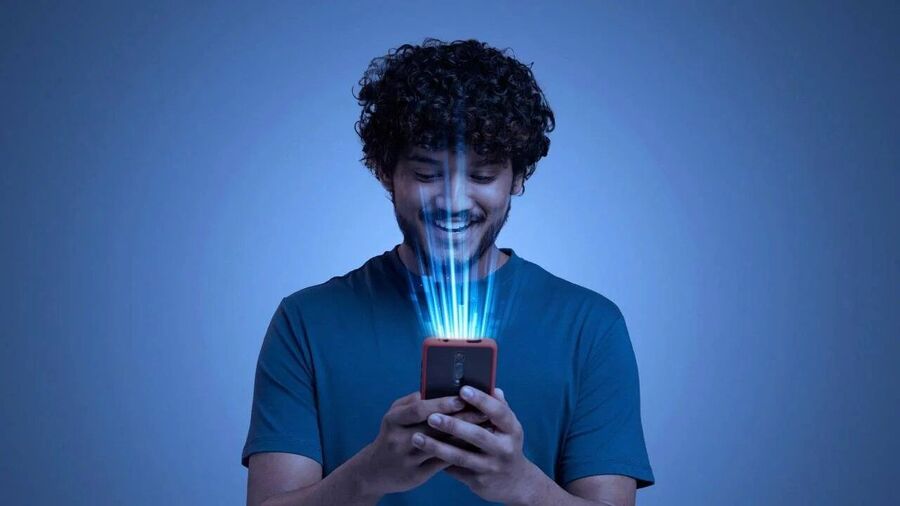Man looking at glowing phone