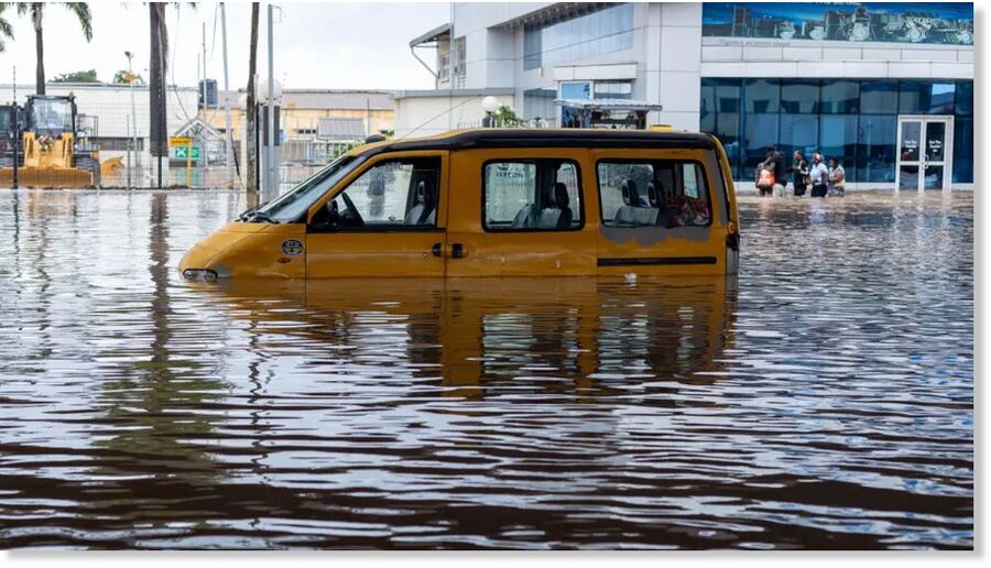 Vehicles and homes are submerged in floodwater in the Ghanaian capital