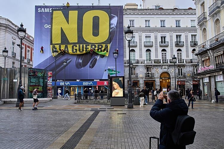 Greenpeace activists hang a banner reading in Spanish, 