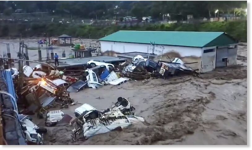 Click to enlarge Vehicles are washed away after flash floods caused by incessant overnight rain, in Rajouri, Jammu and Kashmir, Sunday, July 19, 2026.