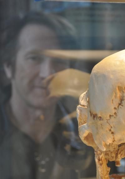 Click to enlarge University of Arizona's Michael F. Hammer with an ancient hominid fossil.