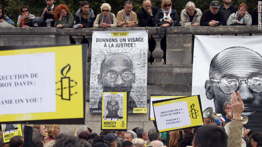 Click to enlarge People hold placards on Wednesday during a demonstration in Paris against the execution of Troy Davis