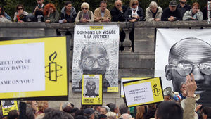 People hold placards on Wednesday during a demonstration in Paris against the execution of Troy Davis