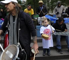 Click to enlarge A child plays along with an Occupy Wall Street drum circle in Zuccotti Park on Sunday