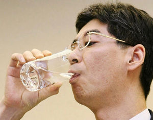 Yasuhiro Sonoda drinks a glass of decontaminated water