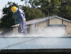 A worker uses a high-pressure washer/Fukushima