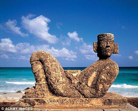 A Mayan sculpture installed near a beach