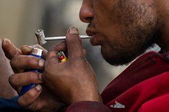 Click to enlarge A drug addict smokes crack