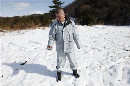 Click to enlarge a Zen priest, looks at the readings on his Geiger counter