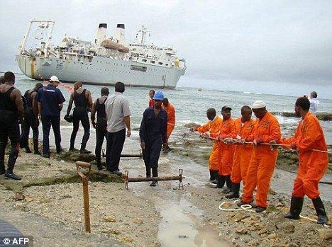 Workers haul part of the fibre optic cable