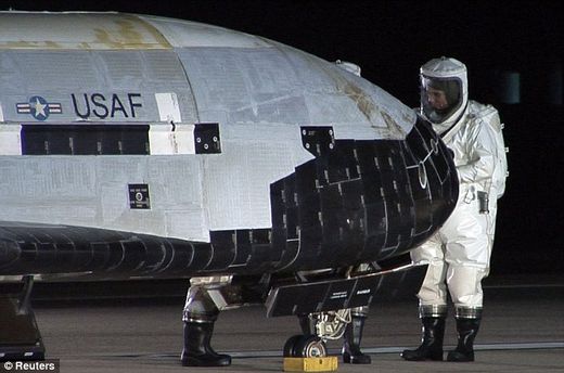 Scientists in protective suits inspect