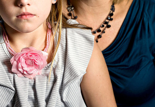 Ainsley, who began showing signs of puberty at age 6, and her mother.
