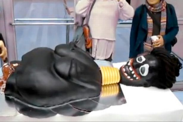 Click to enlarge racist cake