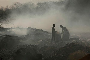 People collect scraps from a garbage dump in Hyderabad, India.