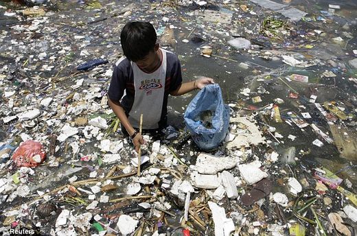 boy in ocean garbage