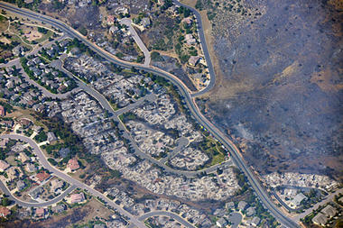 This aerial photo taken on Wednesday, June 27, 2012, shows burned homes in the Mountain Shadows residential area