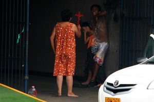 Attacker and woman crucifix