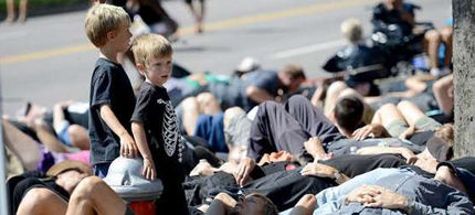 Hundreds of protesters participate in a 'human oil spill'