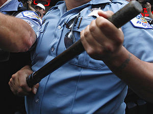 Police officers hold batons 
