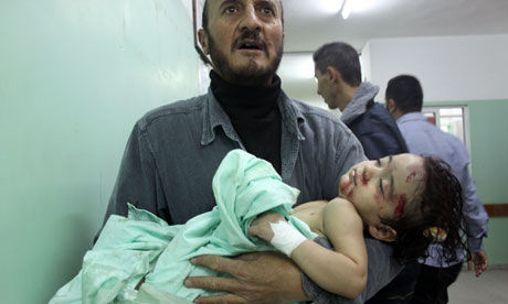 Palestinian man carries a wounded child