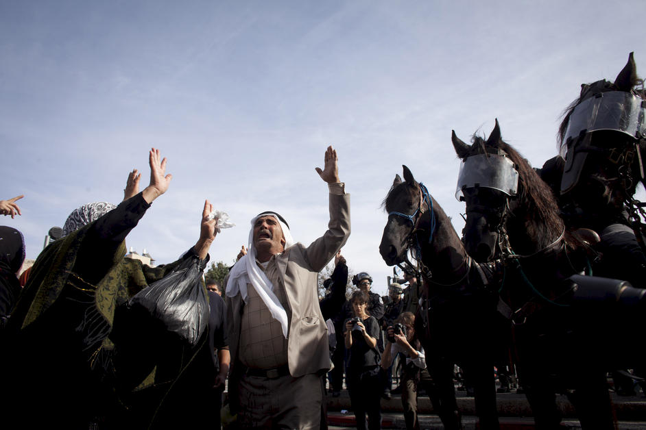 Palestinians protest next to Israeli police 