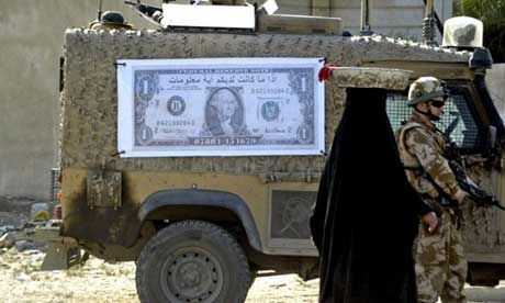Click to enlarge An Iraqi woman, in 2008, walks past a British soldier and military vehicle